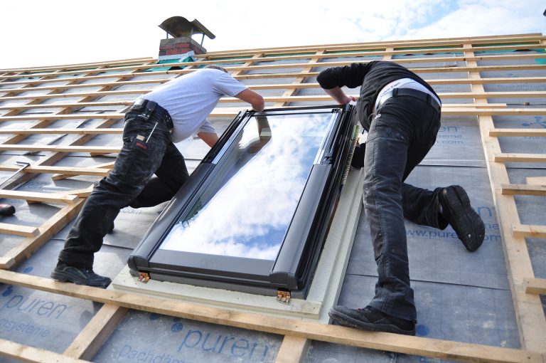 two men assembling a roof skylight window 2026 01 07 05 51 53 utc